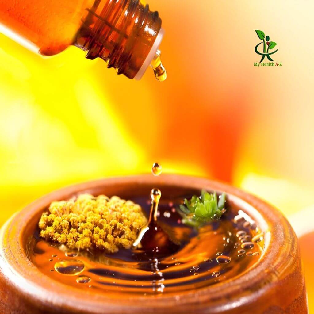 Bottle pouring liquid into a container with a blurred background and &