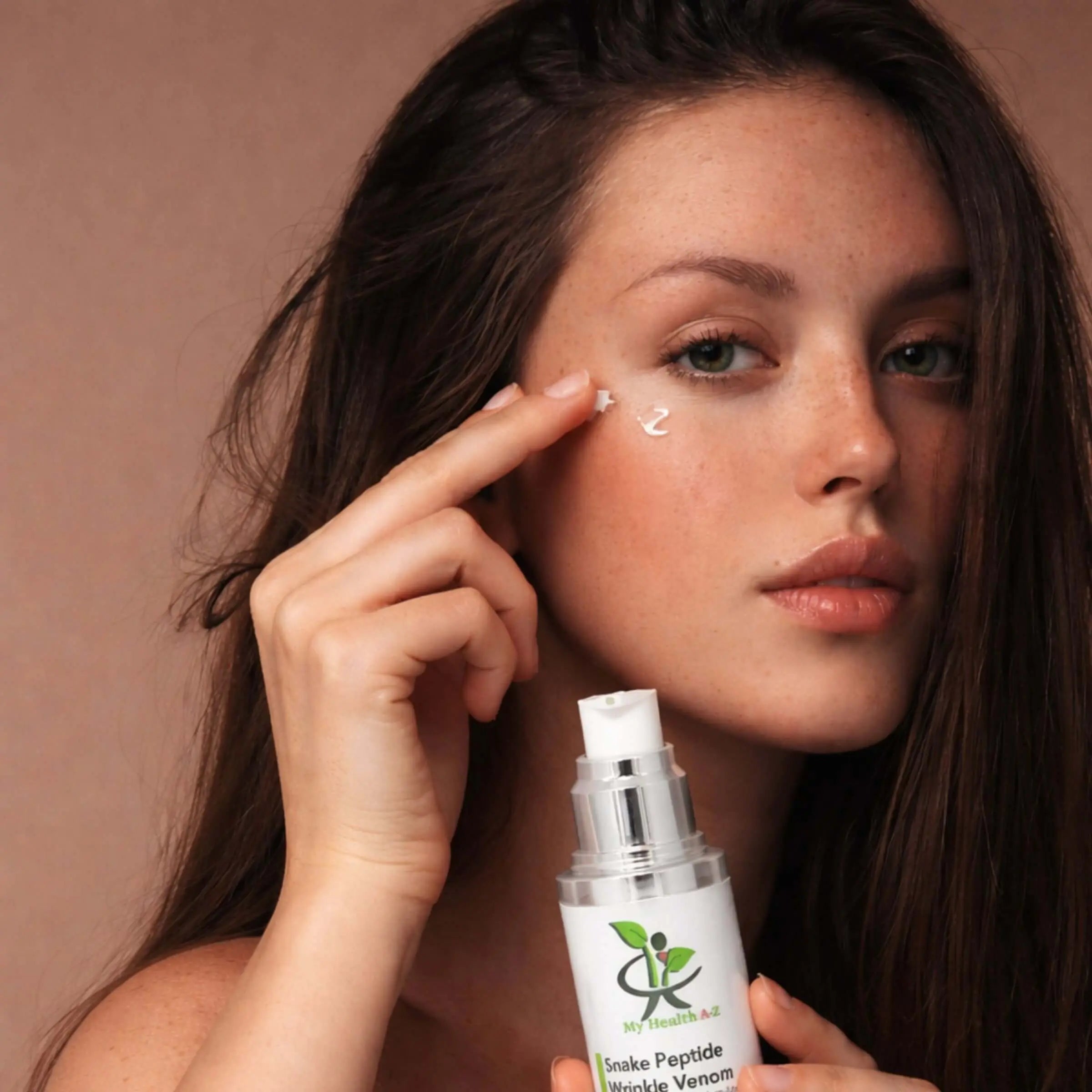 Woman applying My Health A-Z Snake Peptide Winkle Venom onto her face