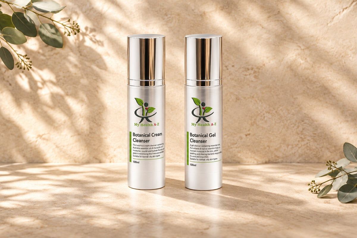 Botanical Cream Face Cleanser and Botanical Gel Facial Cleanser arranged on pale sandstone with eucalyptus leaves⠋