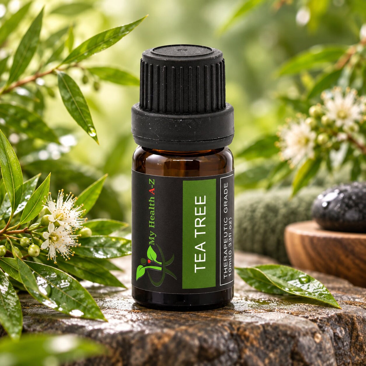 Tea Tree Essential Oil with tea tree leaves and white blossoms in the background⠋