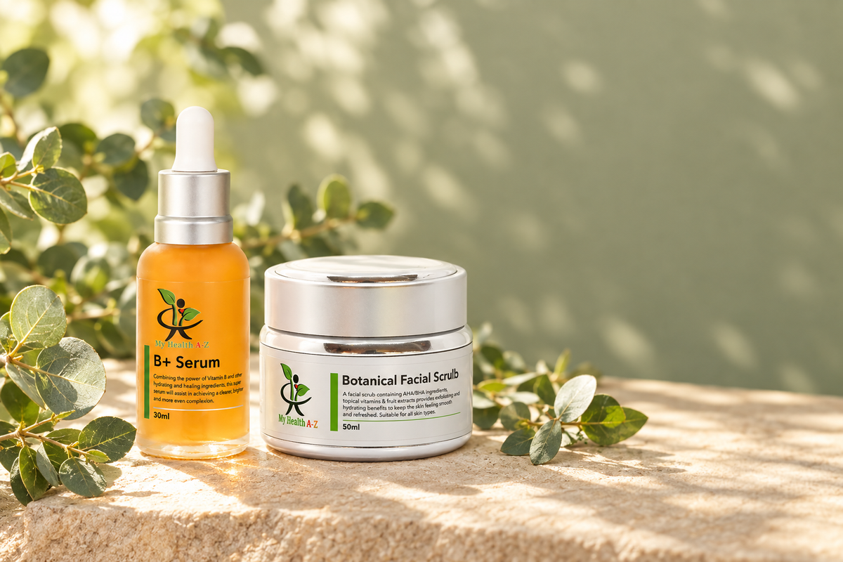 B+ niacinamide serum and botanical exfoliating facial scrub arranged on pale sandstone with eucalyptus leaves