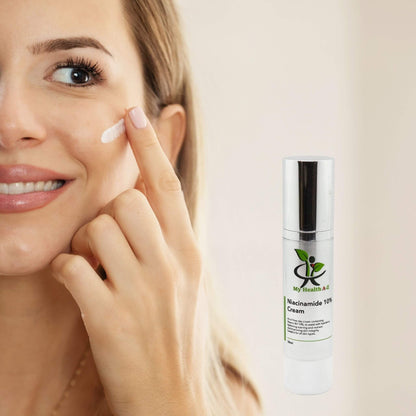 Woman applying cream to her face with a bottle of Niacinamide cream labelled 'My Health A-Z ' on a beige background