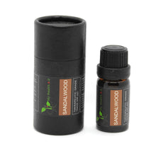 Load image into Gallery viewer, black cylinder and next to it a 10ml sandalwood essential oil bottle
